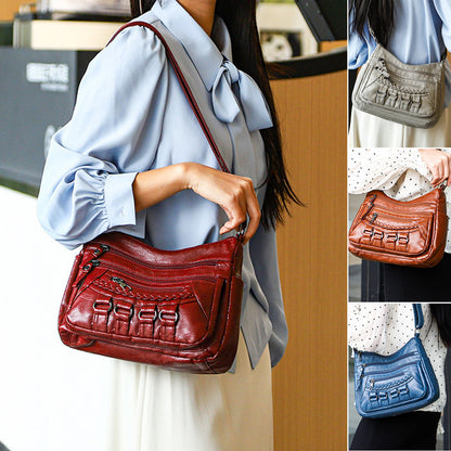 Duża torebka damska z wieloma kieszeniami, noszona na ramieniu